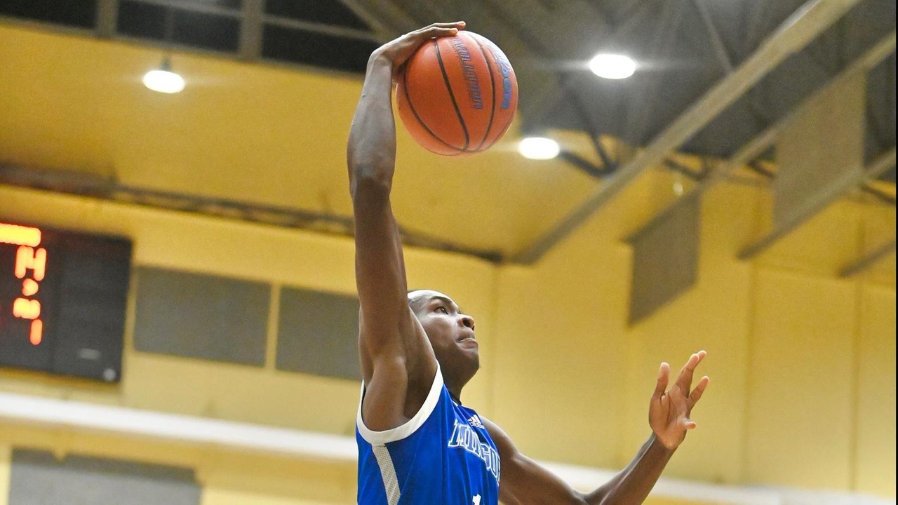 The University of The Bahamas Terrance Higgs (Blue 10) goes up for a dunk during the game against Customs Department Taxmen in UB Homecoming action at the Kendal Isaacs Gymnasium Friday, November 7. UB won 99-63. UB ATHLETICS