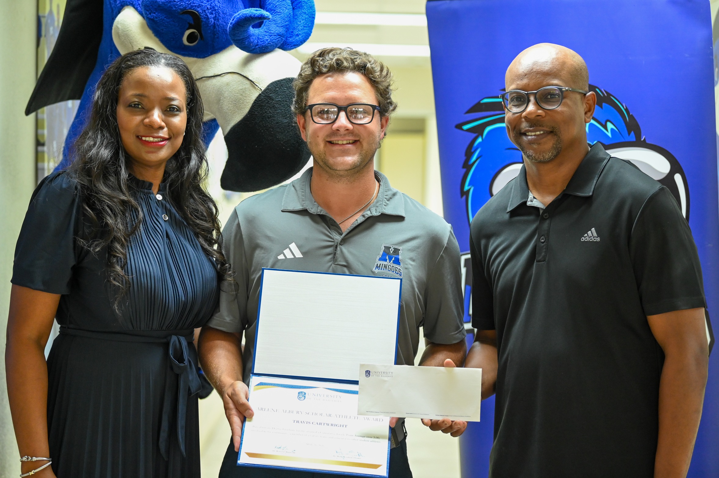 The University of The Bahamas Mingoes golf player Travis Cartwright (center), Class of 2026, receives the Arlene Albury Scholar Athlete Award. Also in the photo is Kimberley Rolle (left) , Athletic Director and Kyle Albury (right), son of Arlene Albury. (UB ATHLETICS)