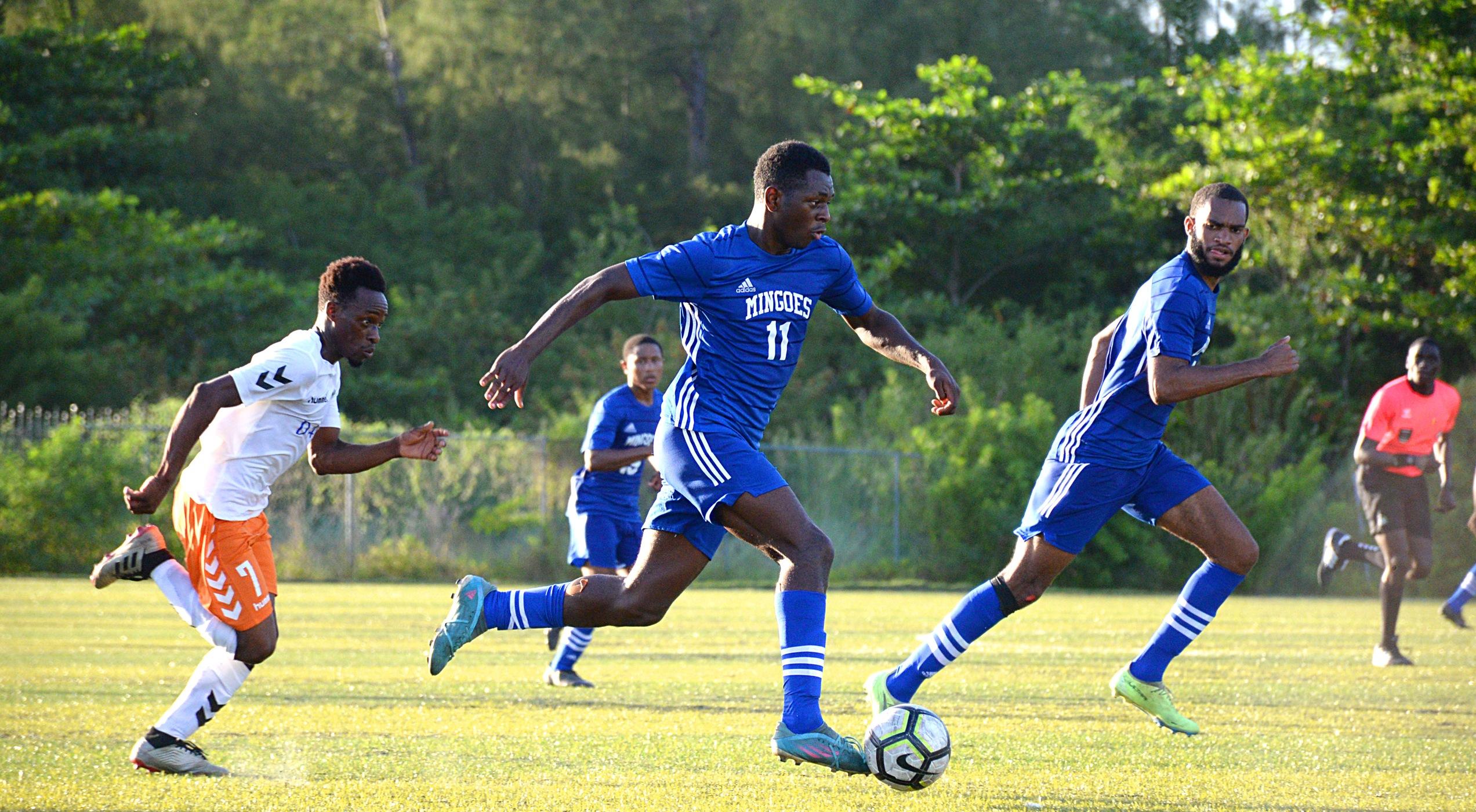University of The Bahamas midfielder Ronaldo Green (blue 11) charges to the goal against United FC in their BFA match Sunday November 6, 2022 at The Roscow R.L. Davies Field.  Green was eventually fouled, awarded a penalty kick, and subsequently scored the lone goal for UB. (UB ATHLETICS)