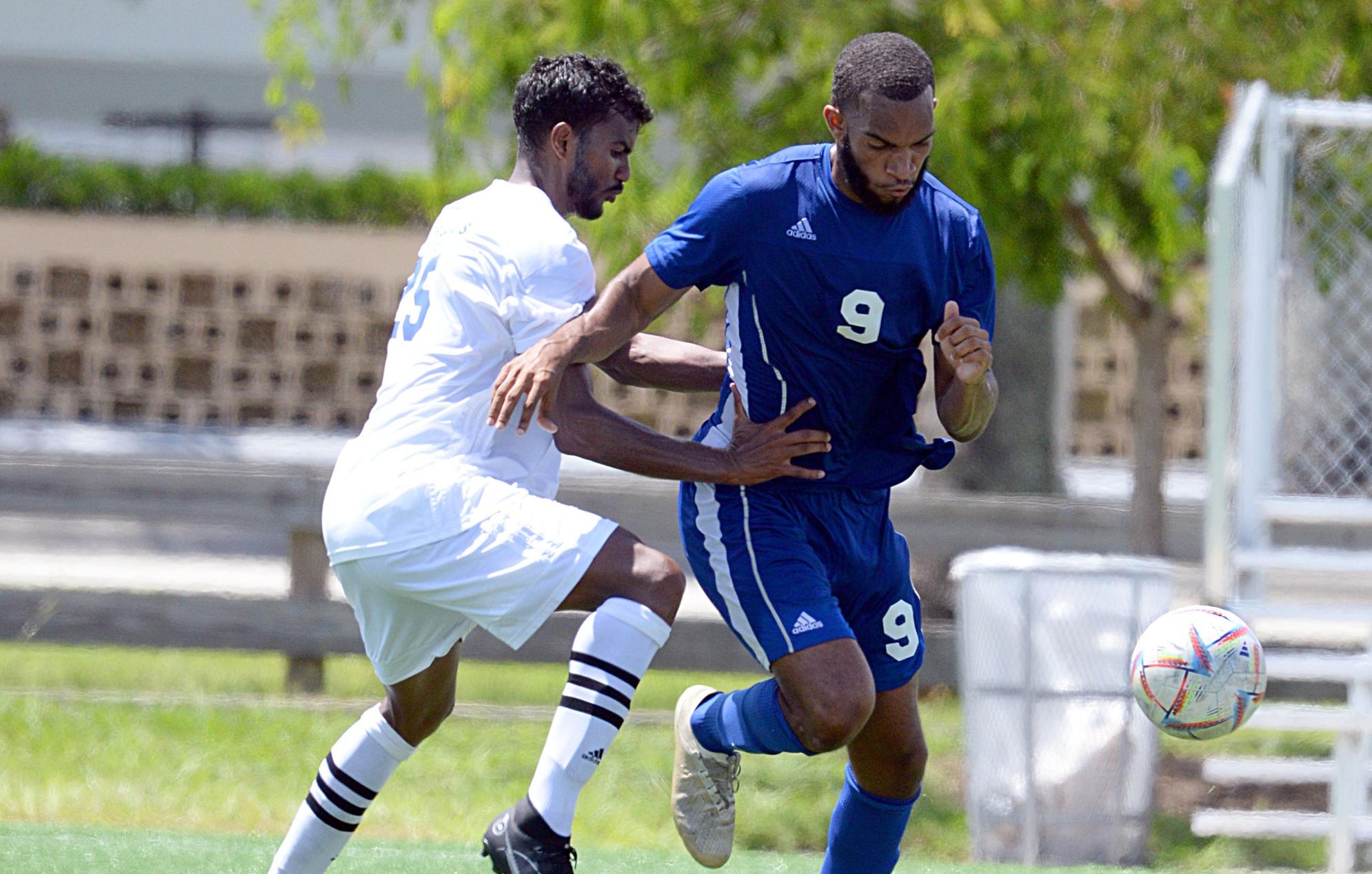UB Mingoes men&rsquo;s soccer striker Resean Rolle (blue 9) moves the ball against Florida Palms University during their match September 10, 2022 in Miami. The Mingoes lost 5-1.