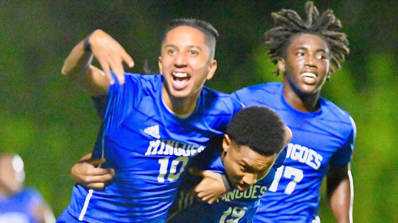 University of The Bahamas Mingoes forward Philip Pilgrim (Blue #10) and midfielder Kevin Thomas (Blue #17) celebrates with goal scorer Nathan Wells (Blue #19) against United FC Wednesday, February 5 at the Roscow Davies Soccer Fields. Mingoes lost 3-2.