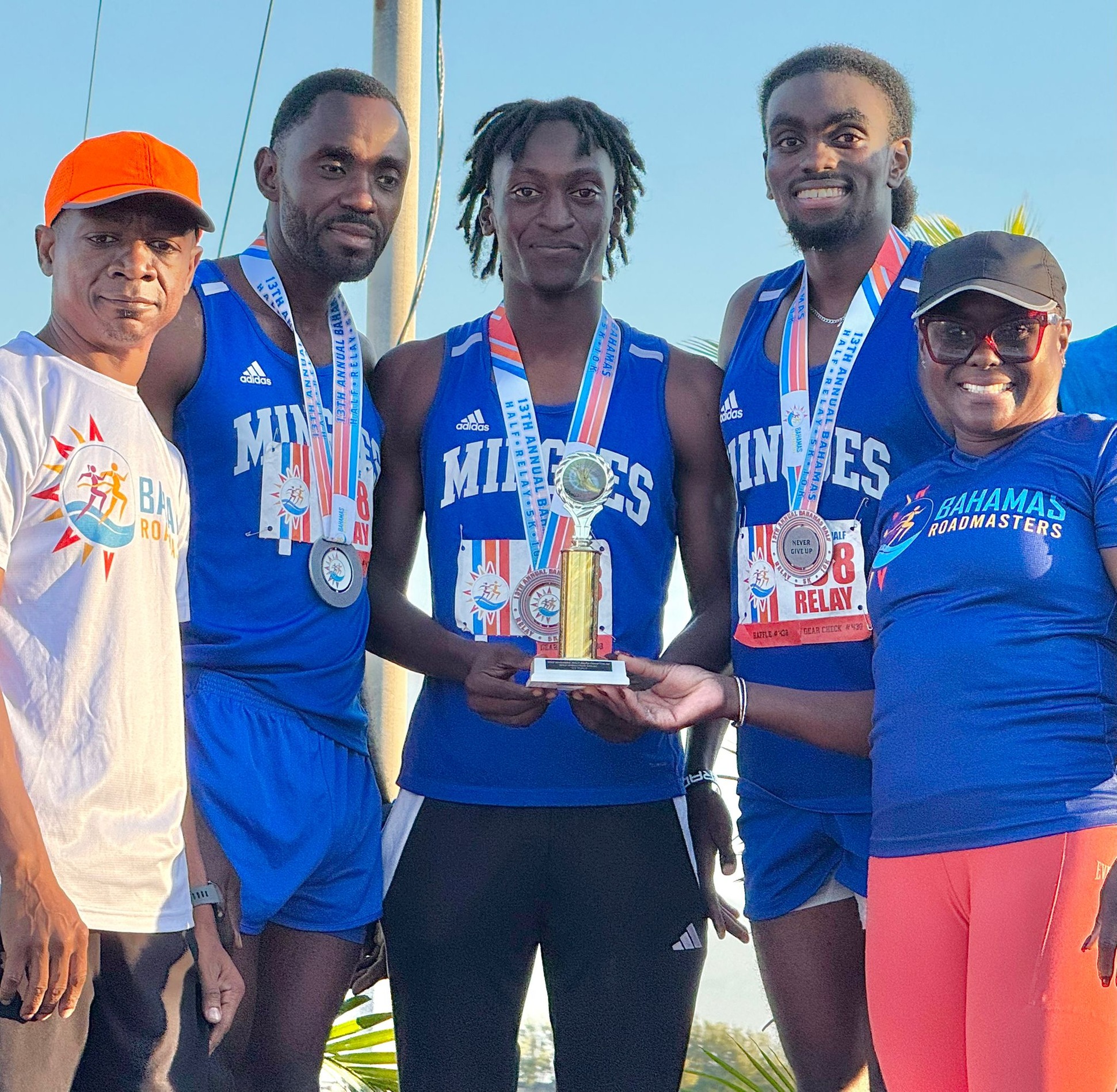 The University of The Bahamas men&rsquo;s relay team of Kenold Jean, Jackson Ozias and Lhevinne Joseph receives their trophy. The trio won the 2025 Roadmasters Half Marathon relay on Sunday, November 22 in northwest New Providence. UB Athletics.
